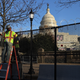 Workers put concertina razor wire along the top of the 8-foot ‘non-scalable’ fence that surrounds the U.S. Capitol